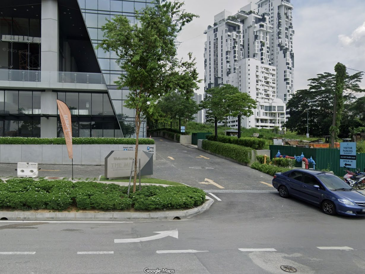 Open-air visitor parking beside The MET Corporate Towers